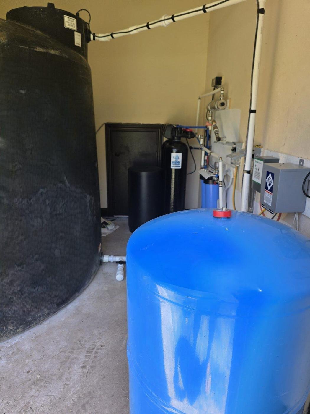 Well room rebuilt by Simple Water Solutions with a storage tank, new booster pump, pressure tank and filtration